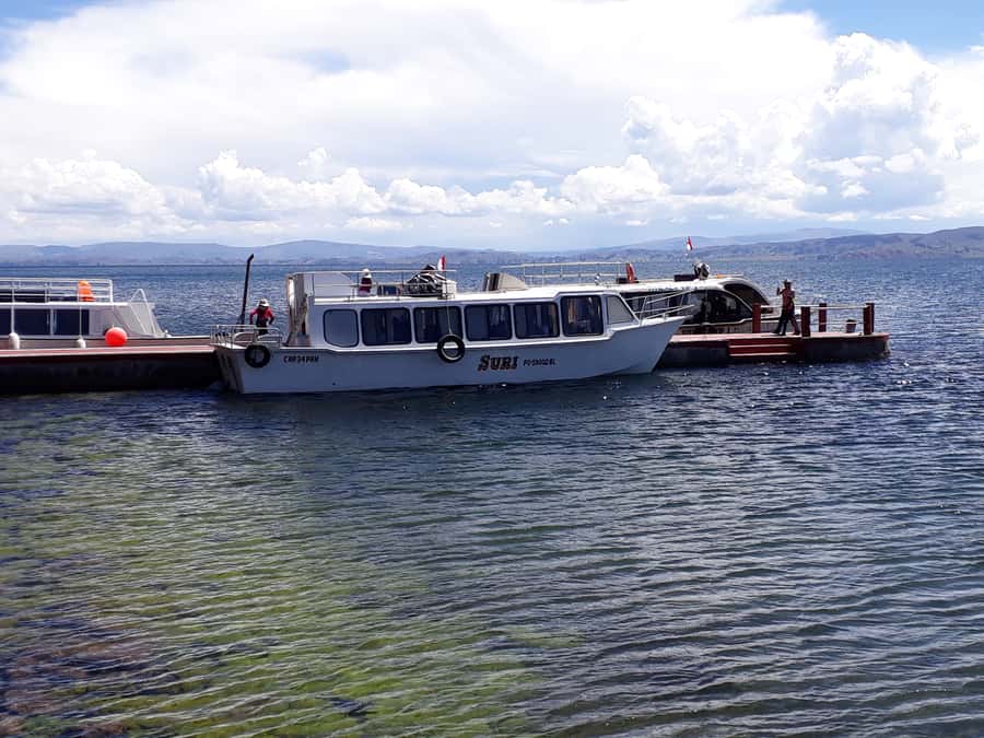 From Puno: Floating Islands of the Uros Half-Day Tour - Stepping onto a floating island